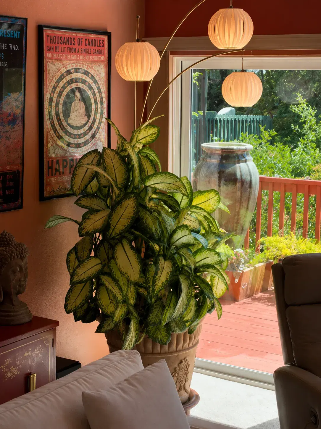 Warmly lit home altar with plants and art